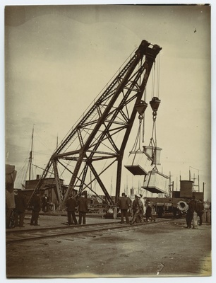 Tallinn, the port, the crane loads the boxes on the platform wagon.  duplicate photo