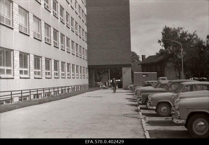 Parking cars in front of the Industrial Project building.