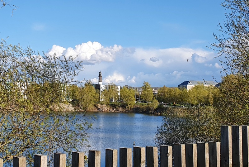 View of the Lasnamäe battery holes towards the Upper Lighthouse (Punane fire tower). rephoto