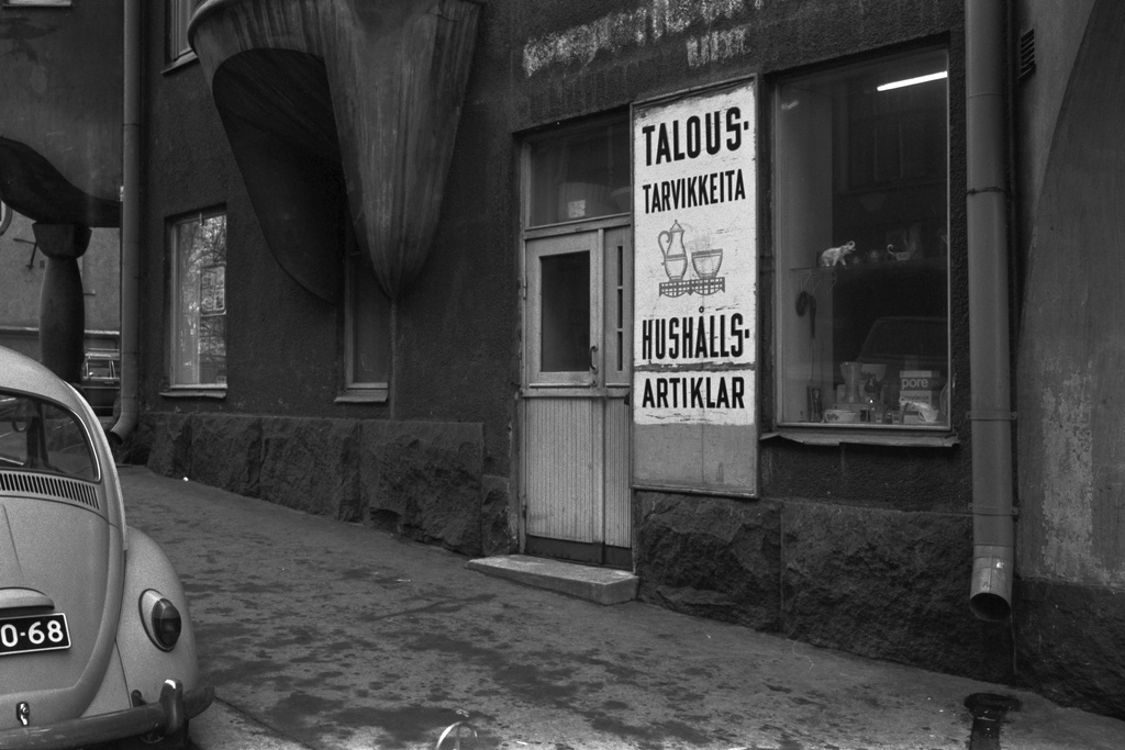 Katajanokka, Vyökatu 10. Taloustarvikekaupan sisäänkäynti ja näyteikkuna Vyökatu 10:ssä. Ikkunassa erilaisia taloustarvike- ja koriste-esineitä.