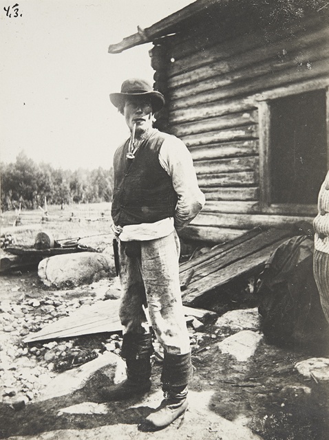 Torpper Kalliolaks stands in front of a hundred years old smoker