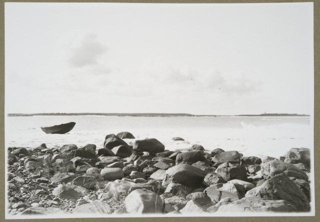 Coastal stone and fishing boat in the Raahe Archipelago in spring