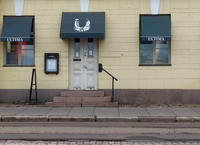 Nainen Gustav Pauligin yrityksen konttorin ulkoportailla. Läntinen rantakatu (Västra kajen) 16 (=  Eteläranta 16). rephoto
