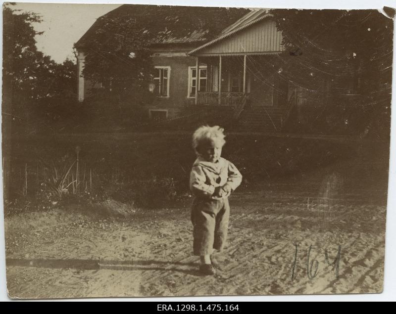 Small child in front of the Service Manor building