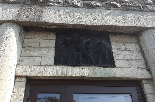 Barreljeef with employees on the wall of the building in Tallinn rephoto