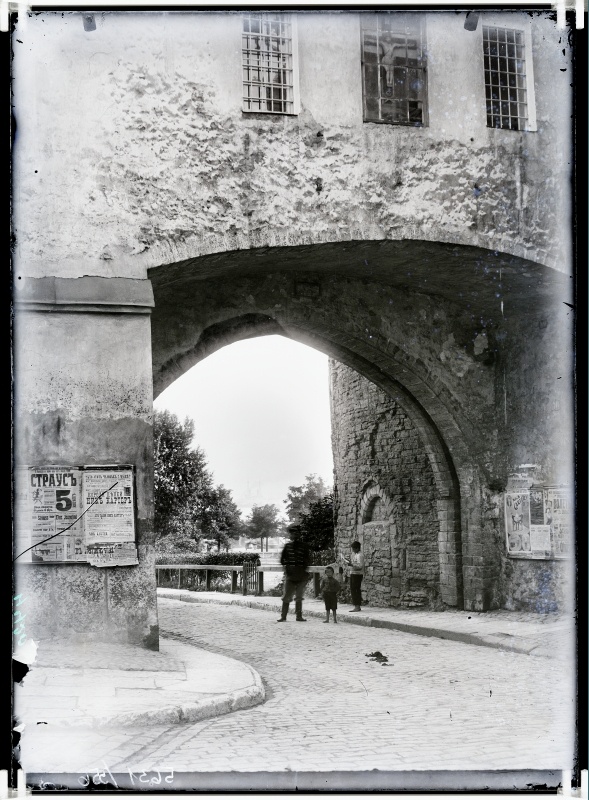 Beach gate, view from the beach gate to the sea. Announcements on the walls of buildings.