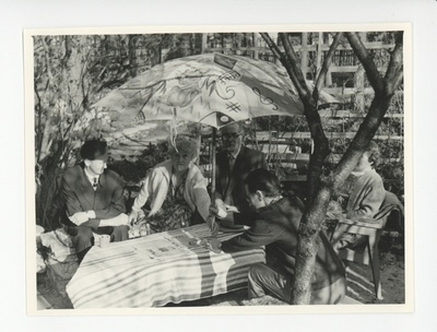 Tuglased külalistega aias päikesevarju all  duplicate photo