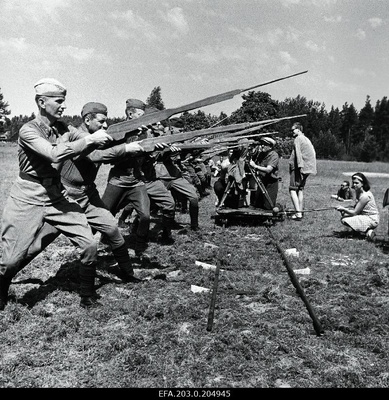 Films from Tallinn Film "The People in Soldiers". The soldiers' battle attack is filmed by the operator-designer Mihhail Dorovatovski. Arvi Hallik and Heino Raudsik are in front of the row with wooden guns.  similar photo