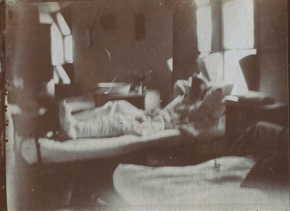 Blurred photograph of man in hospital bed