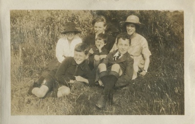 Family group seated on the grass  duplicate photo