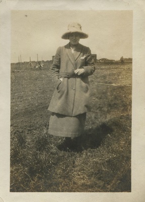 Woman standing on the edge of a field  duplicate photo
