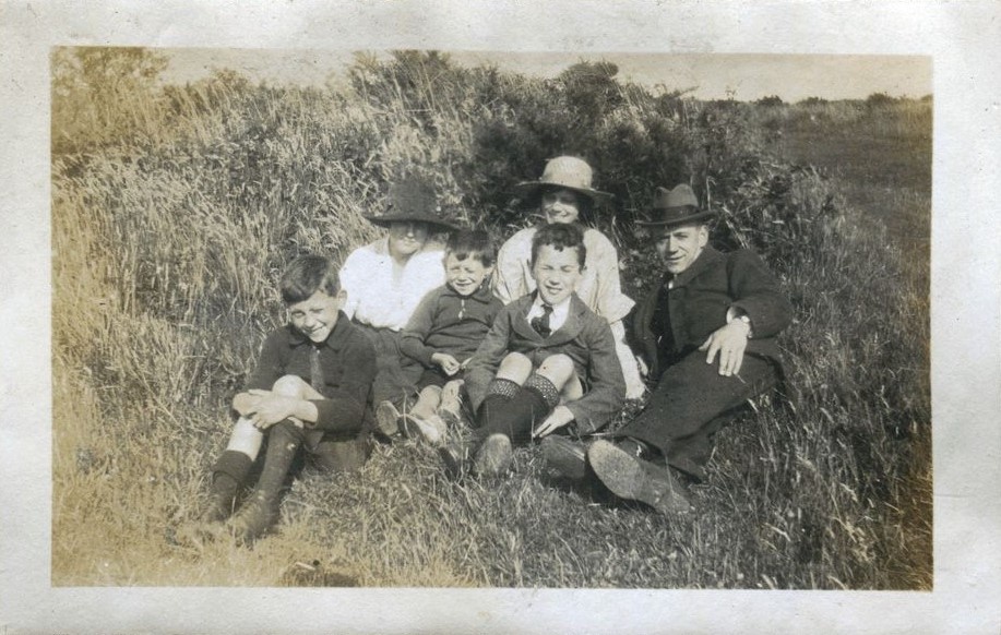 Family group seated on grass, Patcham 1920