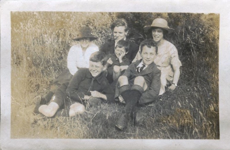 Family group seated on grass, Patcham 1920