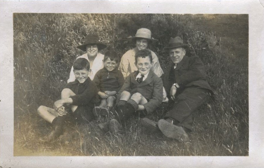 Family group seated on grass, Patcham 1920