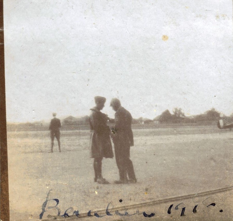 Two men standing talking in foreground, Beaulieu airbase 1918