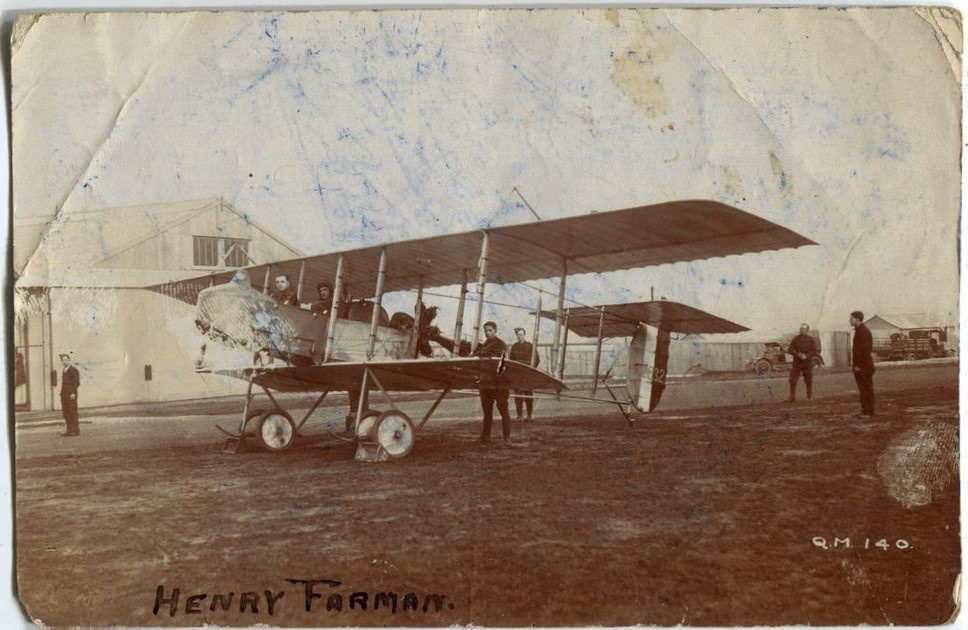 Men posed around a Henry Farman F.20 (2832) bi-plane at airfield