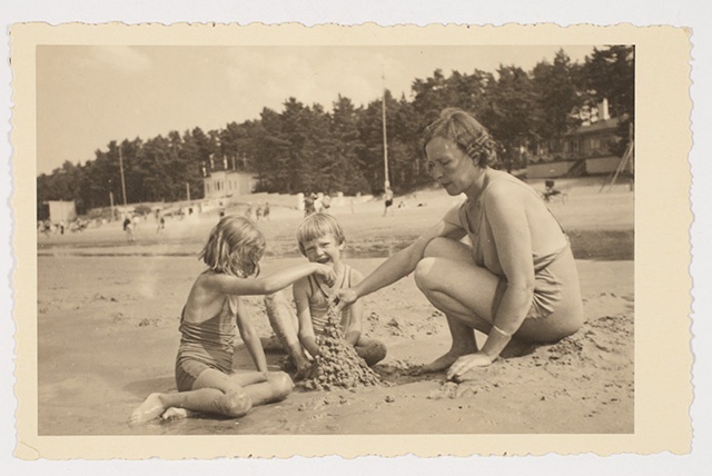 Woman with children on the beach