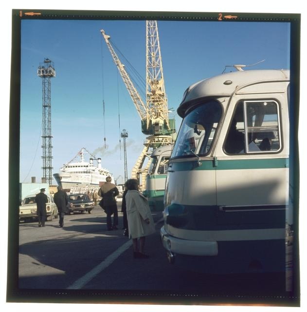 Tourists in the port. A lot of bus in the port.