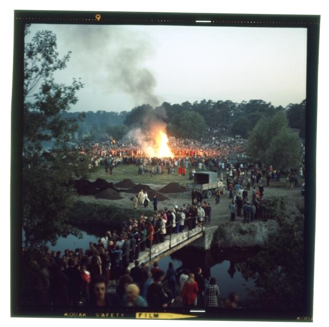 Pirita river views. On the shore a big fire and many people.
