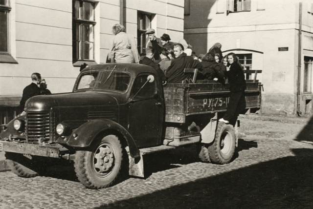 Students travel to practice in an open truck box