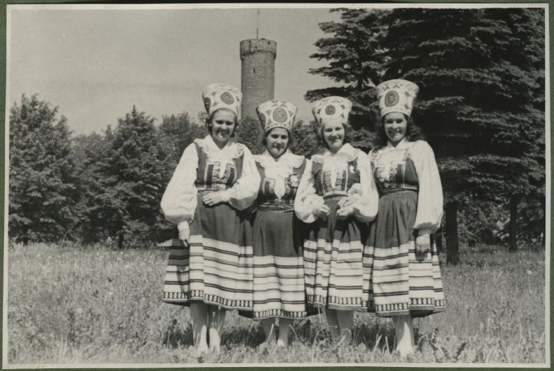 XII üldlaulupidu 28.-29. juunil 1947, Tallinnas.
Neli rahvariietes neidu poseerimas foto jaoks. Taustal paistab Pika Hermanni torn.