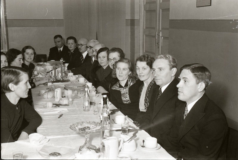 Inimesed peolaua taga istumas (Noor-Eesti kirjastuse jõulupidu 18. detsembril 1938)