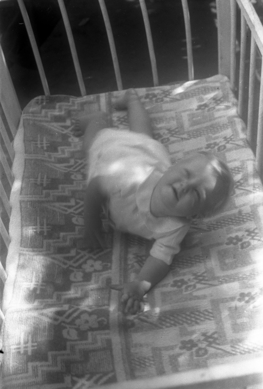 Väike laps võrevoodis õues