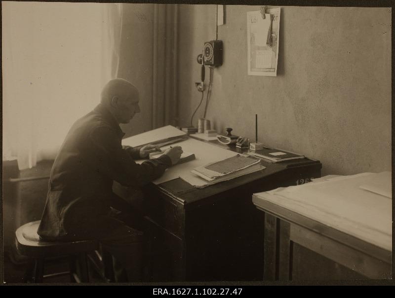Older printer behind the desk