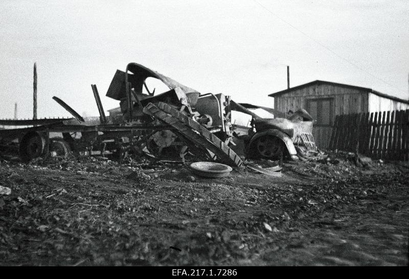 Destroyed German front building material storage area with garage, boiler and barracks.