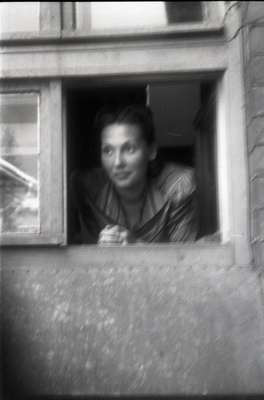 Naine väiksest aknast välja vaatamas  similar photo