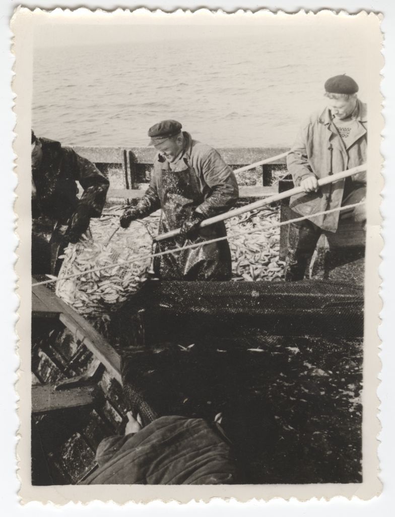 Wooden fishermen at sea lifting the fish boat