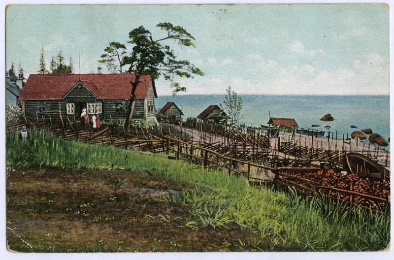 A small village. Fishing houses on sandy hills, behind the sea.