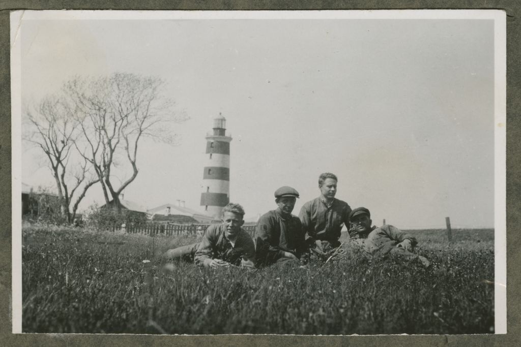 Group of men in the background of the fire tower of Osmussaare, in the middle of the steamboat "Sekstant" pootsman