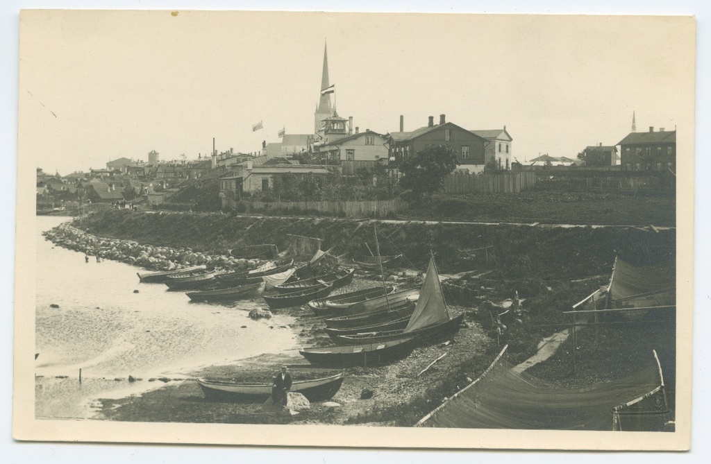 Tallinn, fishing port with boats, behind Oleviste church.