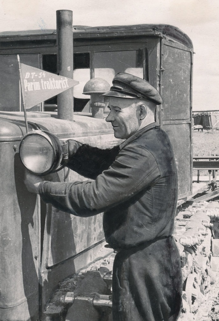 Foto. Kalinini nim. kolhoosi 2. brigaadi traktorist K. Ideon   traktorile rändvimplit kinnitamas juunis 1956.a.