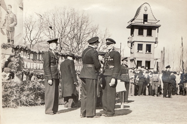 Firefighting tour men in front of the tribute in 1948.