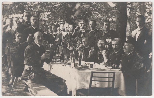 Tuletõrjevormis seltskond peolauas vabas looduses