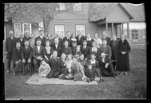 Clothing for men, women and children - group picture in front of the house