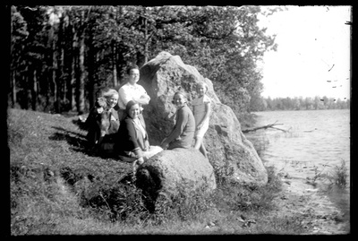 Clothing for men, women and children - company with a dog at Kalevipoja stone ? Near Lake Saadjärvi  similar photo