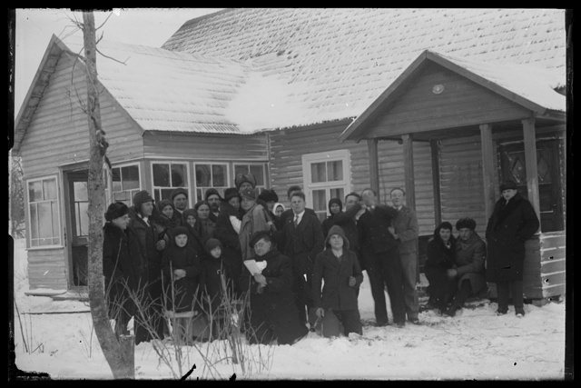 Men's and Women's Clothes - group pictures of men and women in winter clothes in front of the house