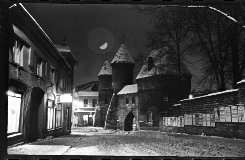 The crossroads of Valli Street and Viru Street, the right wall with announcements, Viru Gate at the end of the street