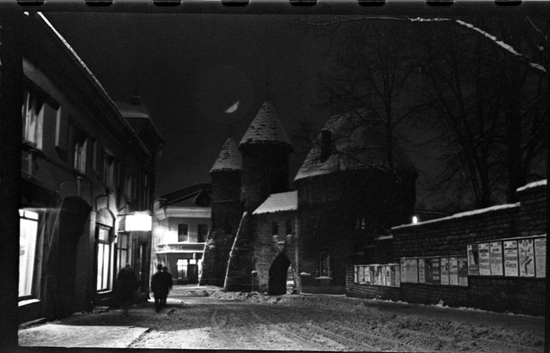 The crossroads of Valli Street and Viru Street, the right wall with announcements, Viru Gate at the end of the street