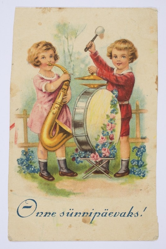 Sünnipäevakaart pasunat puhuva tüdruku ja trummi mängiva poisiga ning tekstiga "Õnne sünnipäevaks!"