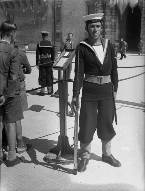 The Royal Navy during the Second World War A16221 - The Royal Navy during the Second World War
Maltese ratings of the Royal Navy mounting guard over the George Cross as it is ceremoniously displayed in Palace Square, Valletta on the first anniversary of Malta being awarded the George Cross by His Majesty King George VI on 15 April 1942.