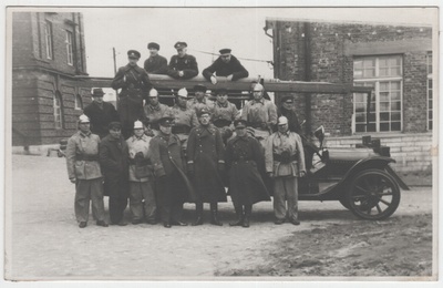Group photo, military form and fire-fighting clothes men at the fire car.  duplicate photo