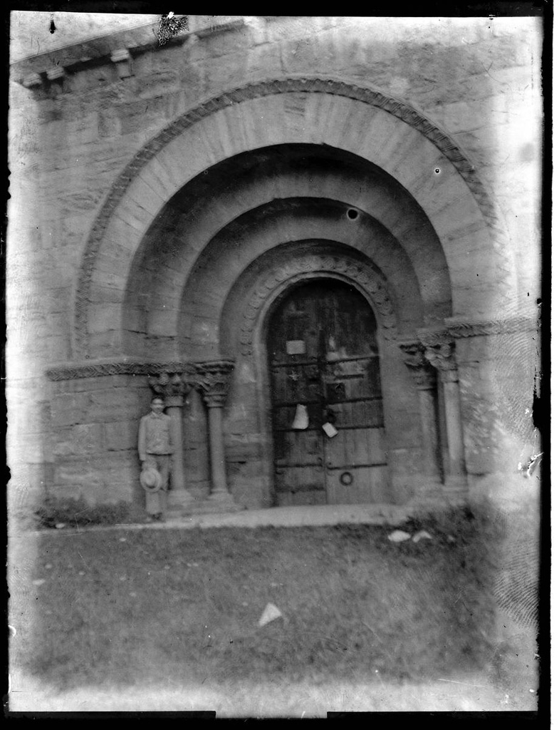 [Santa Maria de Porqueres] - Portrait of a man before the cover of the church of Santa Maria de Porqueres.