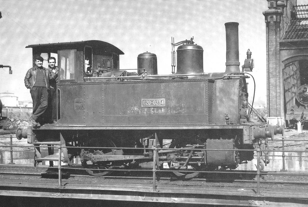 [Girona train station] - Two men set in a locomotive station train Girona.