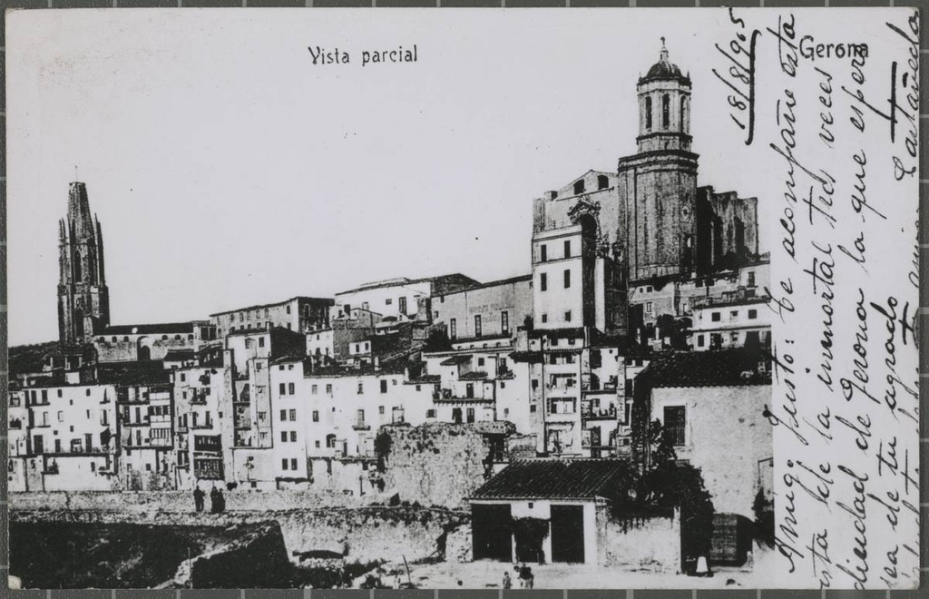 602. Gerona. Partial view - View of the Old Town from Independencia Square First, the remains of a stretch of wall parallel to the river Onyar and the houses of the river In the background stand the bell church of Sant Feliu, the tower of the Old Institute and the Cathedral of Girona.