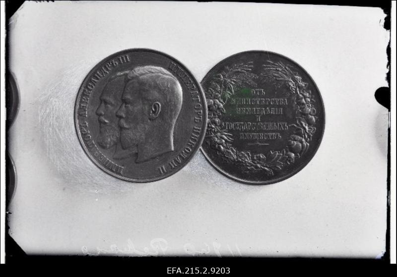 Medali Põllumajandus-saavutused esi- (imperaatorite Aleksander III ja Nikolai II profiilis kaksikportree) ja tagakülg, (foto tellija riidevärvimistöökoja omanik, näitustel medaleid võitnud Rebane).