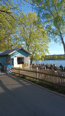 Blue Huvila Café, garden area; outdoor picture, café building and customers on the table and on the sales table rephoto
